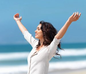 relaxed woman with hands in the air